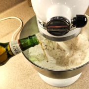 pouring 12 oz bottle of lager to mixture