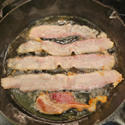 American guinea hog bacon fried in an iron skillet