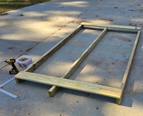 Attaching the deck boards and truing up the skids frame for building our goat tote