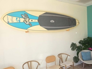 Dr, Craig rides the surf board that is displayed in the lobby on the weekends.