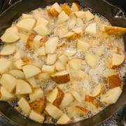 cubed potatoes frying in bacon grease
