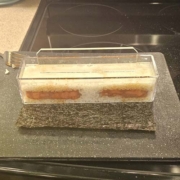 pressing spam and rice in a musubi mold