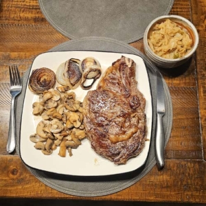 A well-deserved ribeye dinner is ready to eat.