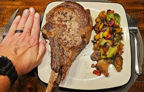tomahawk steak with my hand for reference