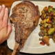 tomahawk steak with my hand for reference