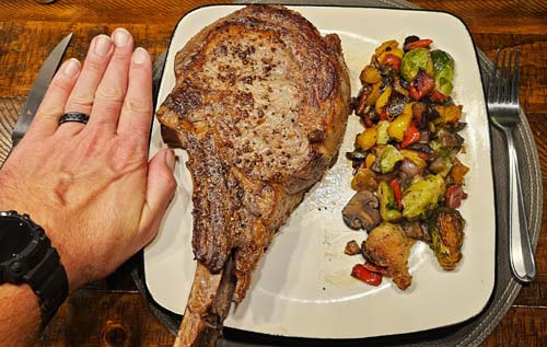 tomahawk steak with my hand for reference