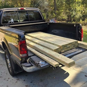 green treated lumber in the pickup bed